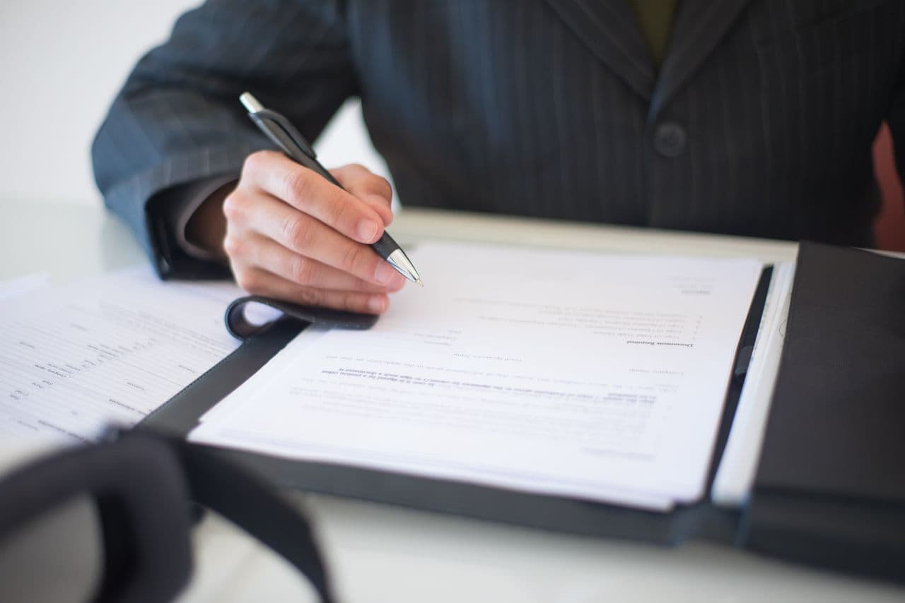 A compliance professional reviewing audit documents and reports