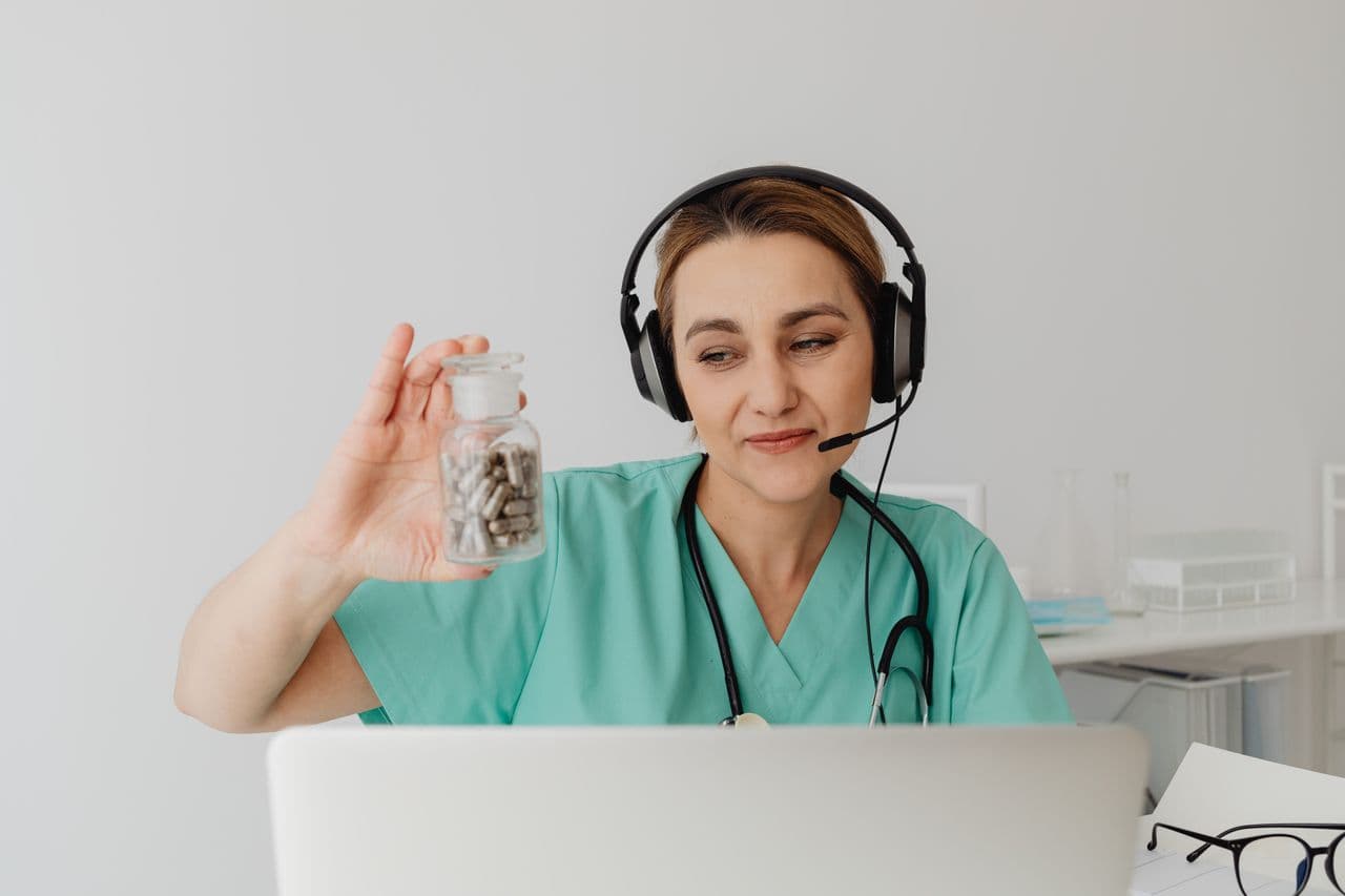 A clinician using digital health records on a laptop