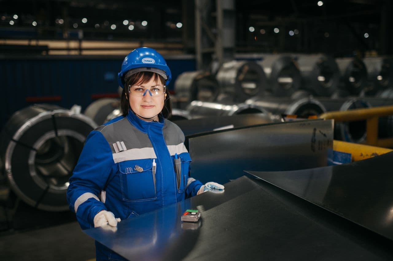 A factory engineer inspecting steel for quality control