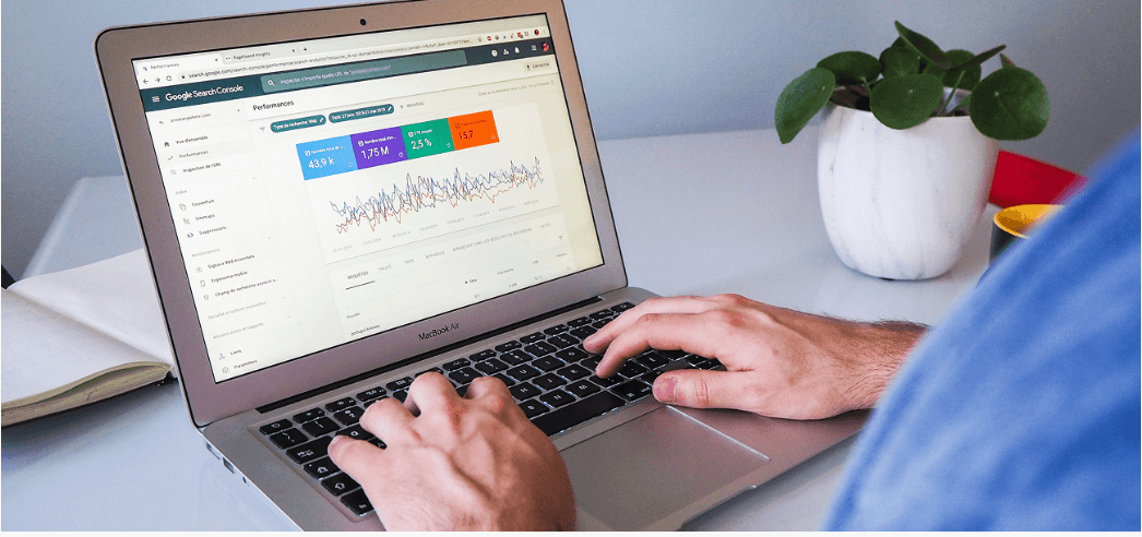 Laptop on a desk showing a Google Search Console performance dashboard